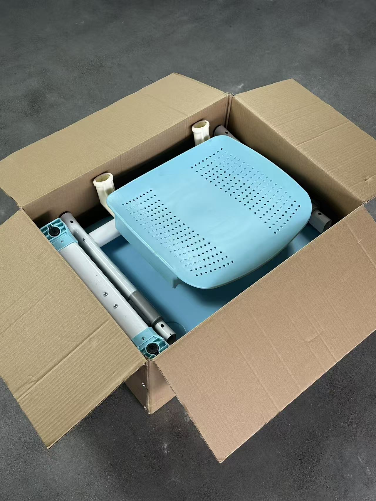 Packed classroom desk and chair components in carton