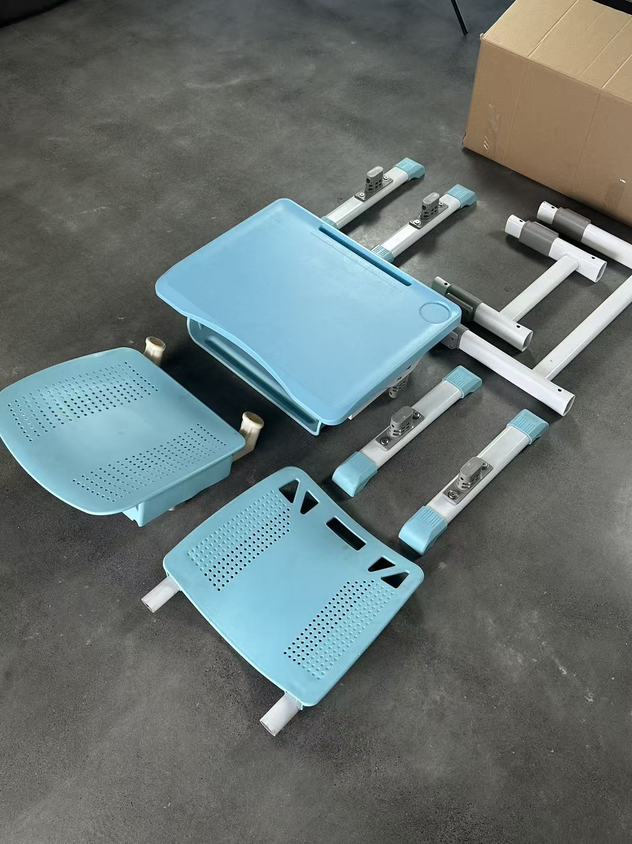 Student desk and chair components before assembly